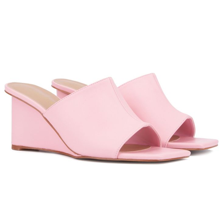 Whether you're heading out for a night on the town or enjoying brunch with friends, the Candie has you covered. This open-toe mule features a chic wedge that combines style with comfort, making it perfect for all-day wear. The versatile design effortlessly complements any outfit, ensuring you look fashionable from day to night. With its blend of elegance and practicality, the Candie is a must-have addition to your wardrobe, offering both sophistication and ease for any occasion. Summer Slip-on Mules With Padded Heel, Spring Wedge Sandals With Deep Heel Cup, Chic Pink Slip-on Slides, Summer Party Wedge Sandals With Stacked Heel, Summer Party Slip-on Slides, Summer Synthetic Wedge Heel Mules, Summer Synthetic Mules With Wedge Heel, Synthetic Wedge Heel Mules For Summer, Summer Wedge Heel Synthetic Mules