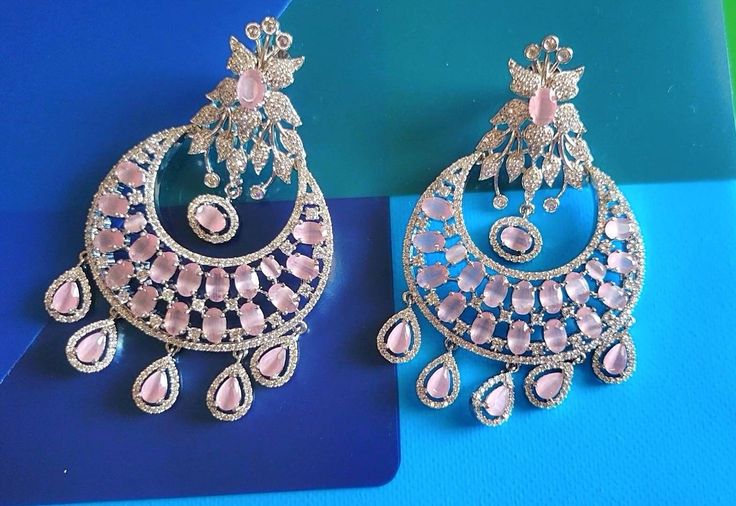 Silver Pastel pink Diamond Earrings Indian Pakistani bridesmaid wedding jewelry in silver plating Indian Jewelry are always a part of all the Indian celebration around the globe . One definitely complete her look once they own it . Beautiful  Indian cz earrings are plated in rhodium plating for longer lasting. This artistic silver cz Earrings looks beautiful  and elegant perfect for all occasion on any outfits you choose to wear (saree, salwar suits, lenga, etc.) *High quality craftsmanship 100% satisfaction guarantee  *Plated in rhodium plating *Earring Closure push black on earring  *base metal for earrings is brass * Earring length 7.7cm *Earring width 4.6cm  *package include earrings  *ready to ship from Houston TX United States GIFT- It comes in gift box perfect for gifting to your mo Rose Gold Earrings For Wedding And Festive Occasions, Silver Danglers For Reception, Festive Rose Gold Wedding Earrings, Elegant Pink Danglers For Wedding, Traditional Pink Earrings For Formal Occasions, Pink Chandbali Earrings For Reception, Elegant Pink Drop Earrings Danglers, Elegant Pink Earrings For Reception, Elegant Pink Earrings For Festive Occasions