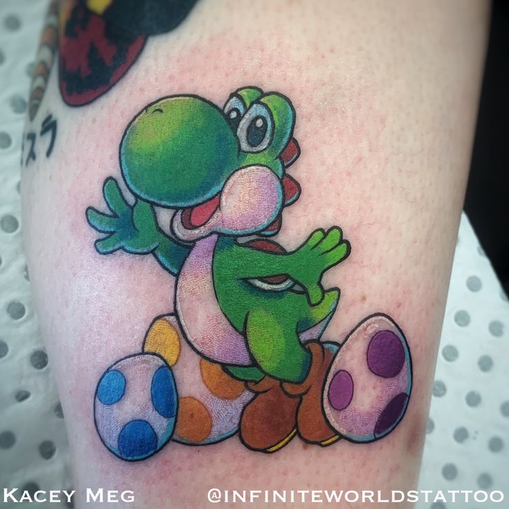 a cartoon character tattoo on the leg of a woman's arm, with an egg and mushroom