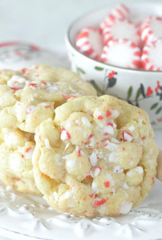 white chocolate peppermint cookies on a plate next to a bowl of candy canes