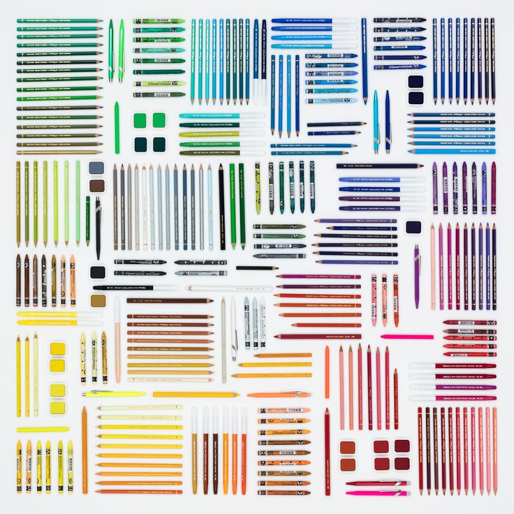 an assortment of different colored pencils and crayons arranged on a white background