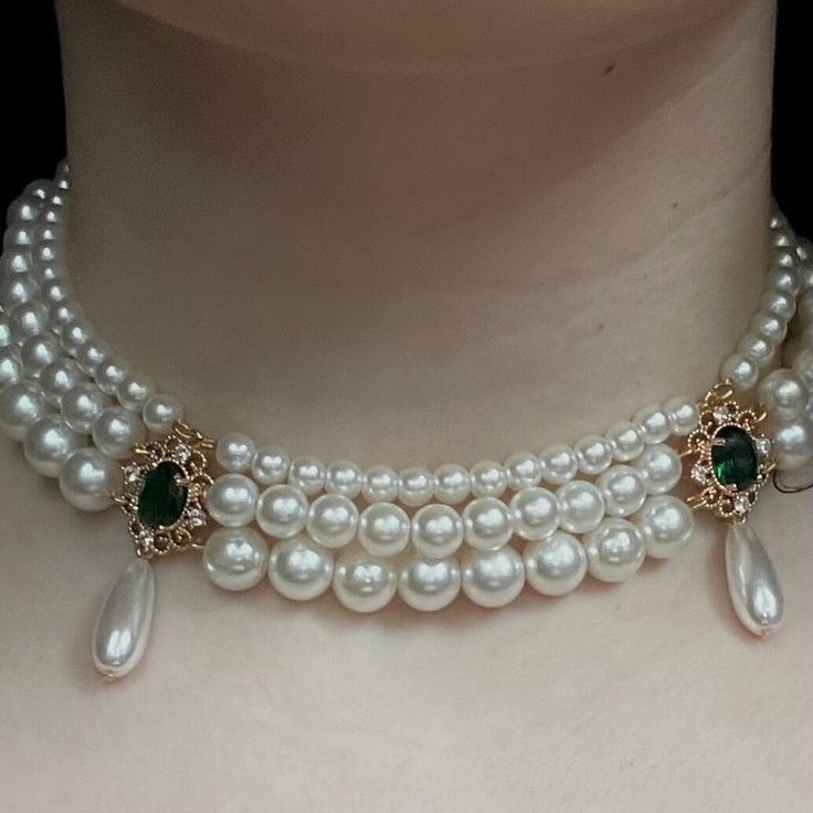 The Josephine Necklace is made up of 3 different ivory colored pearls, sizes ranging from 6mm-10mm, with a dark green cubic zirconia pendant (17mmx22mm) that is perfected with teardrop pearls on each pendant (20mmx8mm). The necklace is finished with a steel box clasp (21mmx10mm). The Length of the necklace is around 16" if you require a longer necklace please reach out. find us on - website: jewelrymilana.com instagram: @milanaajewelry (usa shop)  tiktok: @milanajewelry Elegant Green Necklaces With Pearl Drop, Elegant Green Pearl Drop Necklaces, Formal Green Pearl Necklaces, Green Pearl Necklace With Pearl Pendant, Green Pearl Necklace With Pendant, Elegant Green Pearl Necklace With Pendant, Teardrop Pearl Pendant Necklace For Party, Teardrop Pearl Necklace With Pearl Charm For Party, Elegant Green Pendant Pearl Necklace