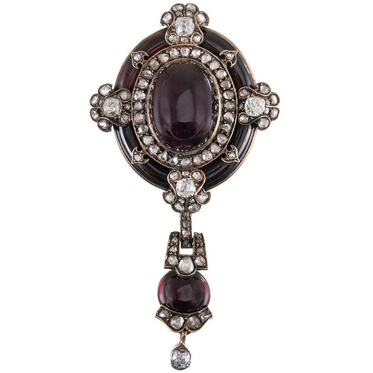 Old European and rose cut diamonds decorate this Victorian adornment from top to bottom, their brilliance brightening the richly-hued garnets that create the focal points of this beautiful creation. 2.25 inches long and 1 inch wide, this piece can be worn as a pin or a pendant, with a removable bale that attaches to a shepherd's hook, as well as a flip up bale that allows the piece to be suspended from a chain at an angle. The back conceals a locket. Offered in its original presentation box. Victorian Pendant Necklace, Gold Star Pendant, Victorian Brooch, Extraordinary Jewelry, Demantoid Garnet, Gold Locket, Antique Brooches, Garnet Jewelry, Pin Pendant