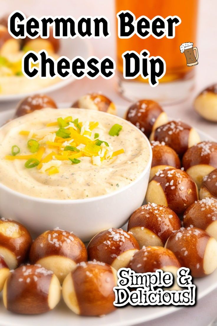 a white plate topped with pretzels covered in cheese dip next to a glass of beer