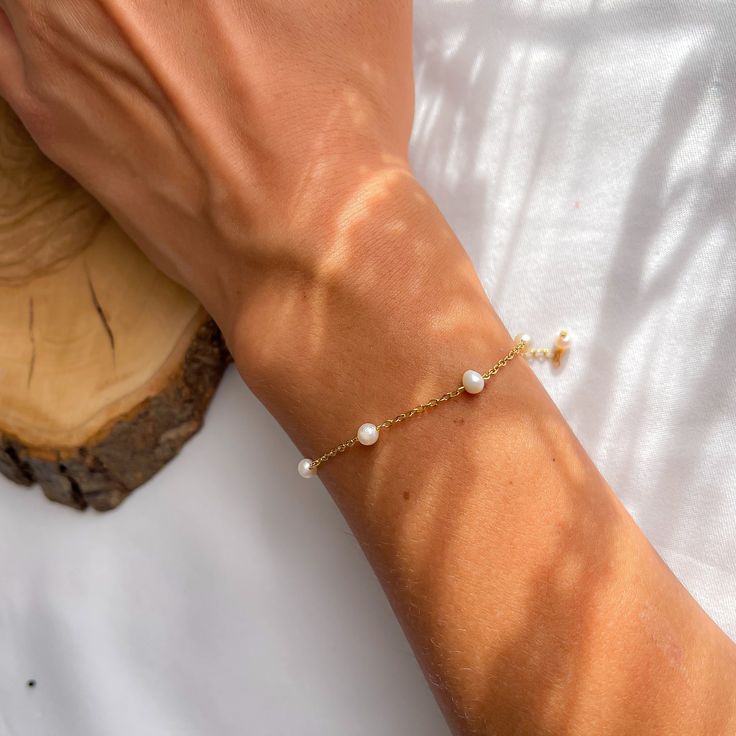 Adorn your wrist with our Minimalist Gold Stainless Steel Pearl Bracelet, featuring 3mm natural freshwater pearls. This dainty bracelet is perfect for any occasion.  The gold stainless steel chain is durable and tarnish-resistant. The bracelet includes a 3cm (1.2 inches) extender, ensuring a comfortable fit. Pair it with our matching Freshwater Pearl Necklace for a complete set.  https://www.etsy.com/listing/1741007228/dainty-freshwater-pearl-necklace-gold?ref=listings_manager_grid Product Features: *Material: Gold stainless steel chain and clasps, natural freshwater pearls *Pearl Size: 3mm *Bracelet Length: Customizable with + 3cm (1.2 inches) extender *Handmade: Yes *Hypoallergenic: Yes Durability: Water-resistant and tarnish-resistant, perfect for everyday wear Why Choose Jewelizeme: *S Minimalist Charm Bracelet With Adjustable Chain For Wedding, Minimalist Adjustable Chain Charm Bracelet For Wedding, Minimalist Wedding Charm Bracelet With Adjustable Chain, Minimalist Wedding Bracelet With Delicate Chain, Dainty Hypoallergenic Charm Bracelet For Weddings, Minimalist Adjustable Beaded Bracelet For Bridesmaids, Minimalist Adjustable Charm Bracelet For Wedding, Adjustable Minimalist Beaded Bracelet For Bridesmaids, Minimalist Beaded Bracelets For Bridesmaid Gift