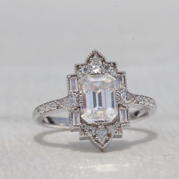 an engagement ring with a large white diamond surrounded by smaller round and baguette cut diamonds