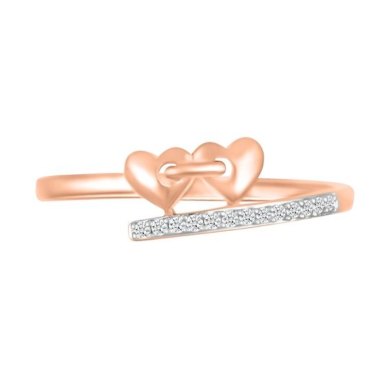 Reinvent romantic expression with the playful linked and bypassing details of this diamond double heart promise ring. Crafted in precious 10K rose gold A pair of sculpted hearts - joined in a link-like design - punctuates one bypassing ribbon. Diamonds line the opposite side to complete the look. This promise ring shines with 1/20 ct. t.w. of diamonds. Rose Gold Rings With Diamond Accents For Valentine's Day, Rose Gold Diamond Ring For Valentine's Day, Rose Gold Double Heart Rings For Valentine's Day, Rose Gold Double Heart Promise Ring, Heart Promise Rings, Peoples Jewellers, Double Heart, Promise Ring, Promise Rings