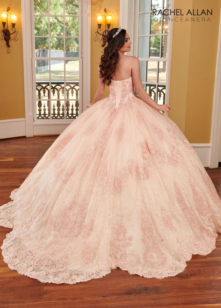 Make a grand entrance in this long strapless dress with A-line skirt by Rachel Allan RQ3110. Strapless glitter tulle and lace quinceanera ball gown with ruched bodice, sequined embroidery applique, scallop train, back lace up closure, and a detachable royal scallop train. Glitter Lace Strapless Quinceanera Dress by Rachel Allan RQ3110 Rachel Allan Alta Couture Collection: Spring 2023 Style Number: RQ3110 Fabric: Glitter Lace, Glitter Tulle, Sequin Embroidery, Beading Please note: There may be a Lace Quinceanera Dress For Debutante Ball, Lace Quinceanera Ball Gown Dress, Elegant Strapless Quinceanera Dress For Sweet 16, Lace Ball Gown For Quinceanera, Quinceanera Ball Gown With Lace Bodice For Prom Season, Lace Quinceanera Ball Gown For Debutante Ball, Prom Quinceanera Dress With Lace Bodice And Tulle, Lace Quinceanera Ball Gown For Prom, Lace Ball Gown For Quinceanera Debutante Ball