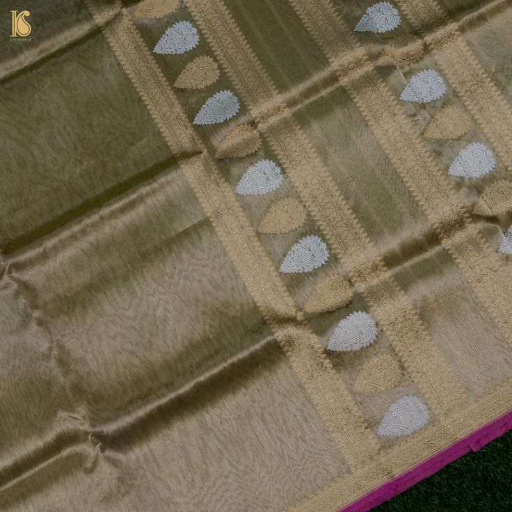 Khinkhwab brings you an exclusive Saree range- specially crafted for Khinkhwab by our weavers for the festive season. This is an exclusive limited edition in Silk and tissue fabrics with an elaborately crafted zari border. The combination of both silk and tissue fabrics makes it a stunning piece. A must buy saree for the festive season. Fabric: Silk by Tissue Weave- Banarasi Golden and silver zari work with zari border. Blouse- Plain with zari border Note- There may be slight color variations du Celebration Tussar Silk Saree With Zari Work, Tussar Silk Saree With Zari Work For Celebration, Celebration Saree With Zari Work In Tussar Silk, Tissue Silk Saree For Celebration And Transitional Seasons, Eid Traditional Wear In Tissue Silk, Eid Tissue Silk Traditional Wear, Eid Tissue Silk Traditional Wear For Ceremonies, Tussar Silk Traditional Wear With Cutdana For Celebration, Tussar Silk Traditional Wear With Pallu For Celebration