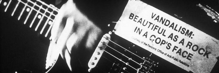 a black and white photo of a sign that says vandalism beautiful as a rock in a coop's space