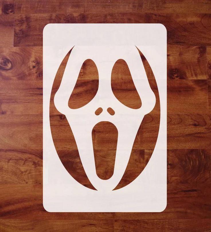 a white sticker with an image of a person's face and arms in the shape of a ghost