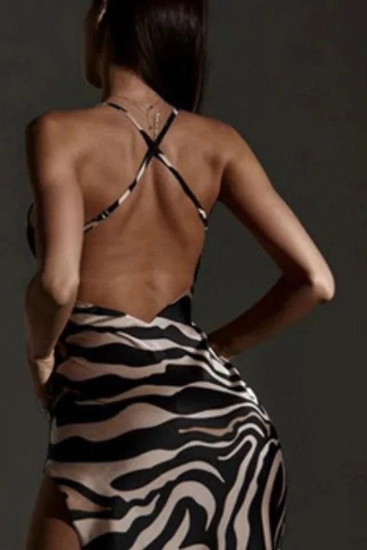 the back of a woman in a zebra print swimsuit