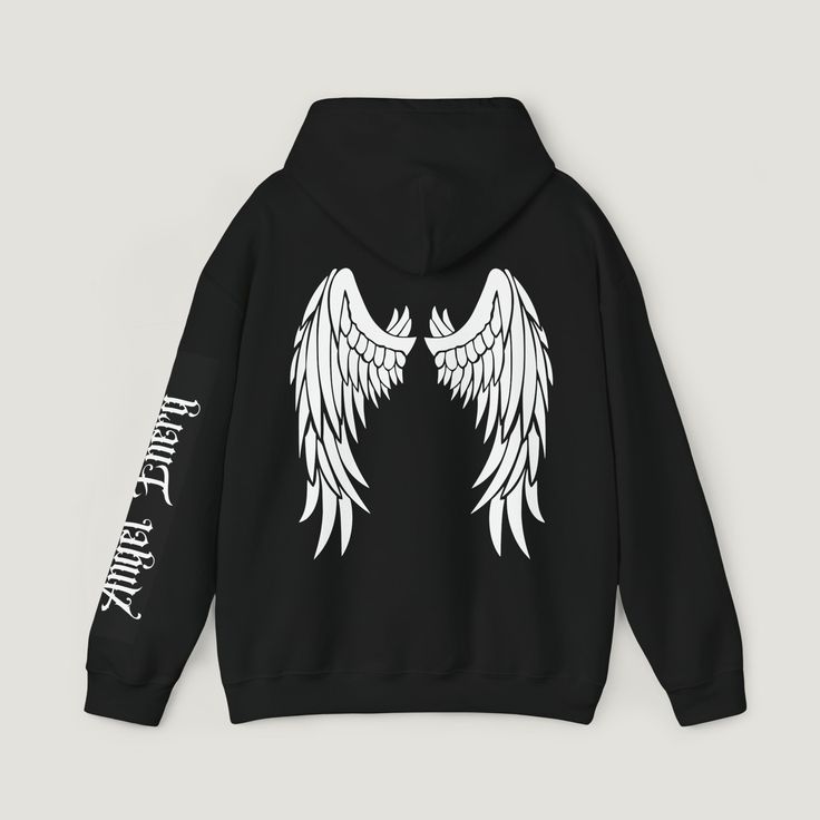 Elevate your style with our black hoodie featuring striking white Angel wings graphic on the back, exuding celestrial vibes. Embrace angelic energy with intricate writing on the sleeve. This classic fit hoodie offers comfort in a thick blend of cotton and polyester, complimented by a color matched drawstring and double-lined hood. Complete with complete with a pouch pocket and tear-away label for a trendy versatile look. Memorial Hoodie Ideas, White Grunge Hoodie Sweatshirt, White Hooded Grunge Hoodie, White Grunge Hooded Hoodie, White Hooded Grunge Sweatshirt, Edgy White Sweatshirt For Streetwear, Edgy White Winter Sweatshirt, White Sweatshirt With Back Print For Streetwear, White Grunge Hoodie For Streetwear