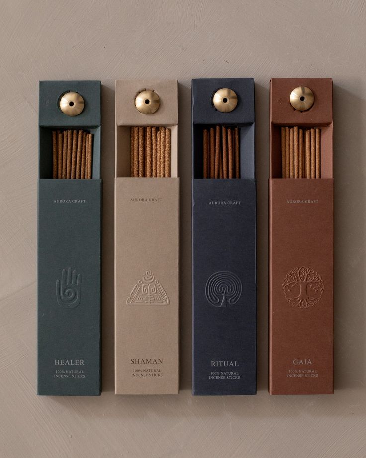 four incense sticks are lined up in different colors and sizes, with the top one open