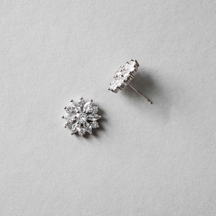 Bright CZ flower earrings for the bride or bridesmaids. Add a floral touch to your wedding day look with these beauties! They are .5 inches long and made with AAA CZ stones set in rhodium silver plating which makes them lead, nickel, and cadmium free. Silver Crystal Clip-on Jewelry, Bridal Earrings With Flower Shape And Prong Setting, Bridal Earrings With Flower Shape For Gift, Formal Flower Earrings With Prong Setting, Formal Flower-shaped Earrings With Prong Setting, Flower Shaped Clip-on Wedding Jewelry, Silver Flower Diamond Earrings For Formal Occasions, Formal Flower-shaped Cluster Earrings With Prong Setting, Formal White Flower Earrings With Cubic Zirconia