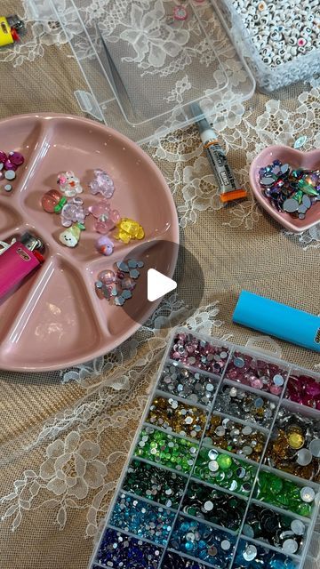 there is a tray with beads and other items on the table next to some pens