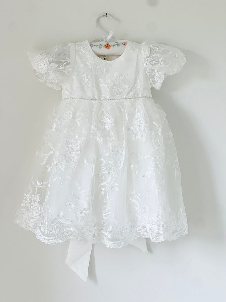 Beautiful and elegant baby girls' lace baptism dress. Two-piece set including a delicately embroidered short-sleeve gown with matching lace bonnet. Complete with a linen and cotton blend liner, to ensure comfort. Feel free to add one of our adorable headbands to complete the look. Lace Dress For First Communion With Short Sleeves, Fitted Embroidered Lace Baptism Dress, Elegant Embroidered Lace Baptism Dress, Short Sleeve First Communion Dress With Lace Bodice, Fitted Short Sleeve Baptism Dress, Lace Baptism Dress With Embroidery For First Communion, First Communion Dress With Lace Patchwork, Elegant Fitted Baptism Dress With Embroidery, Short Sleeve Lace Dresses For Baptism