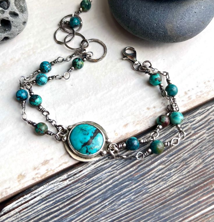 Turquoise encased in sterling silver bracelet. Dimensions: length 19cm/7,5", best fits a 6,5" - 7,5" wrist;   The bracelet is slightly adjustable with hammered circles, oxidized and polished to enhance the detail of the metalwork. The bracelet is handcrafted with care in my studio. Purchases are nicely packaged, ready for gift giving or a special treat for yourself. Bohemian Sterling Silver Bracelets With Natural Stones, Adjustable Sterling Silver Beaded Fusion Bracelets, Handmade Beaded Bracelets In Sterling Silver With Fusion Style, Unique Chrysocolla Bracelets As Gifts, Handmade Turquoise Sterling Silver Bracelets, Unique Turquoise Sterling Silver Bracelets, Bohemian Sterling Silver Bracelet With Natural Stones As Gift, Artisan Turquoise Sterling Silver Bracelet, Bohemian Turquoise Sterling Silver Bracelet