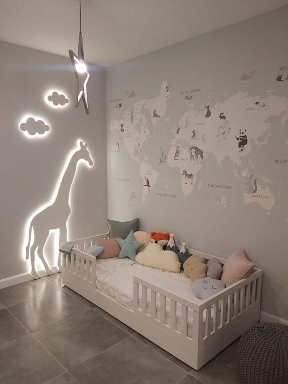 a baby's room with a white crib and world map on the wall