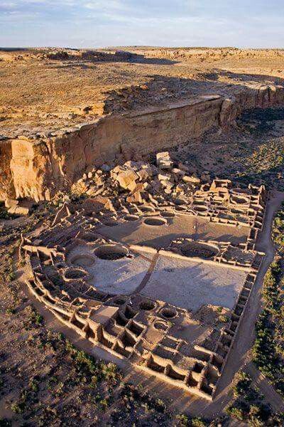 an old building in the middle of some dirt and rock formations with no people around it