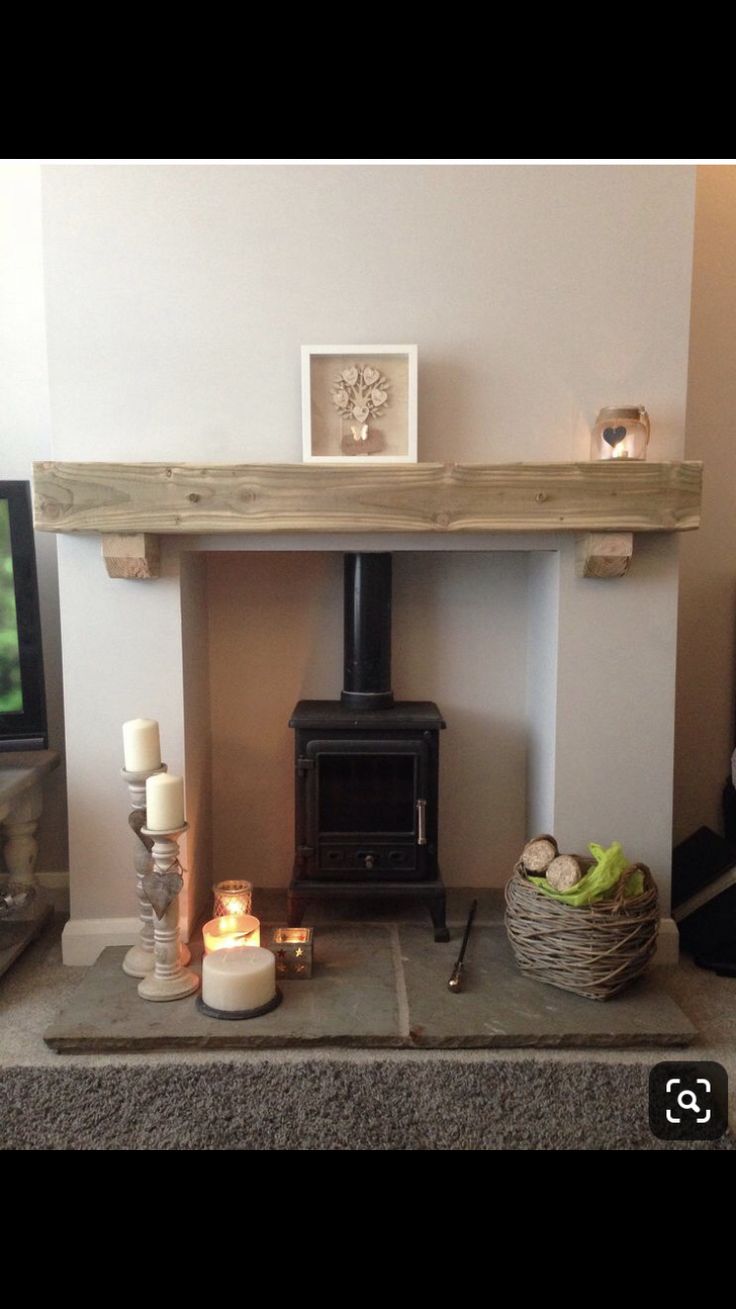 a living room with a fire place and candles