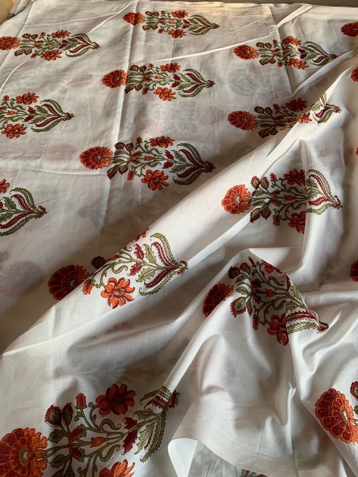 a white sheet with red flowers on it