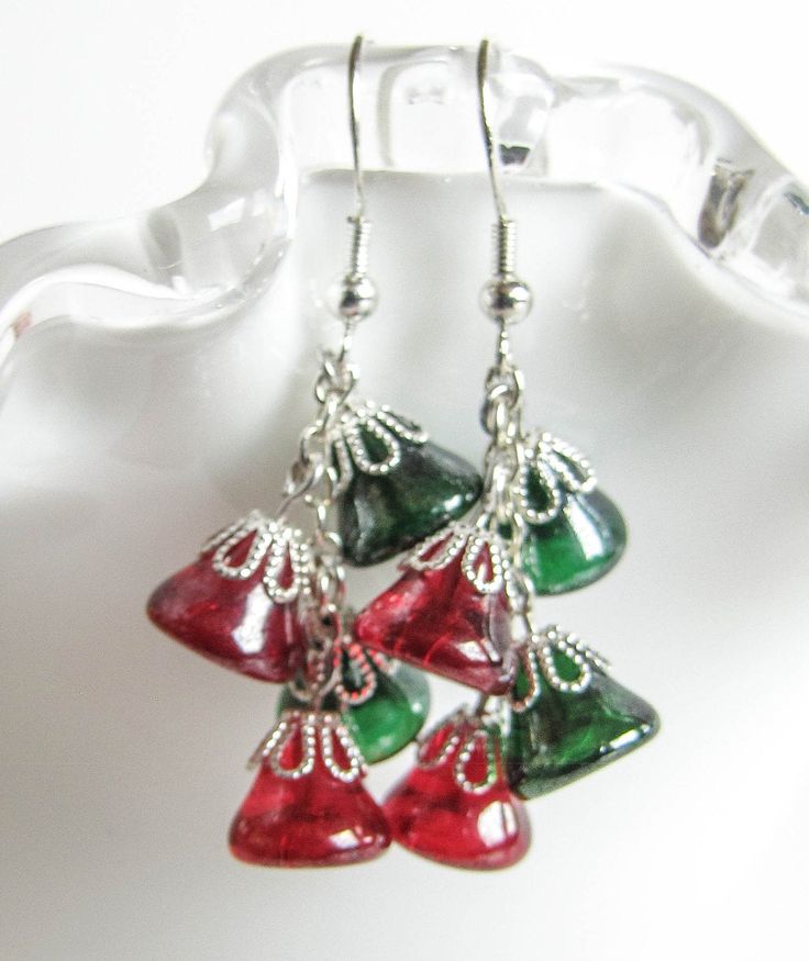 Red and Green Bells hanging from a chain bringing up the Holiday Jingle. Give the Christmas spirit as a gift or keep it for yourself, these earrings will be a great addition to your Christmas sweater . The earrings are 1.75in long (4.5cm) with Surgical Steel fishhook earwire. For larger selection you can visit my shop: http://www.etsy.com/shop/EvaLineJewelry?ref=si_shop Christmas Celebration Jewelry Drop Earrings, Christmas Celebration Drop Earrings Jewelry, Christmas Gift Drop Earrings, Holiday Dangle Earrings With Ear Wire, Holiday Dangle Jewelry With Matching Earrings, Festive Holiday Jewelry With Dangle Shape, Festive Holiday Dangle Jewelry, Holiday Jewelry With Matching Dangle Earrings, Christmas Dangle Jewelry For Celebration