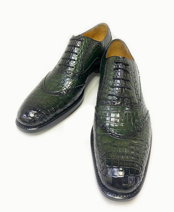 Burnished Alligator Lace-Up Oxford Green Exclusively for C & E, this Completely Handmade, Hand Burnished Genuine Alligator lace-up oxford from the Ugo Vasare collection features Goodyear Welted construction, soft Calfskin lining, a Cap Toe, Decorative Perforations with Pinking Detail, a stitched welt and a full Leather sole! This Style is Available by Pre Order only in Black, Brown, Cognac, Blue, Grey and Green. Once ordered, the shoes will be shipped in 4-6 weeks. Crocodile Loafers, Cordovan Shoes, Alligator Crocodile, Grey And Green, Formal Loafers, Shoe Horn, Wide Shoes, Shoe Tree, Suede Sandals