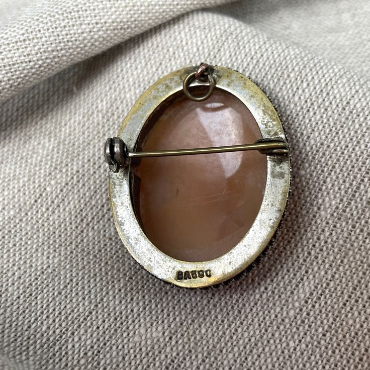 Vintage 1940s carved shell cameo set in a sterling filigree base. Safety clasp. Could also be worn as a pendant. Stamped BS 800. SIZE 1 1/8" x 1 3/8" CONDITION Gently worn, may need polishing. This is a vintage item. It has been used and loved and it has a history. Please examine photos carefully and ask questions, as we are unable to accept returns or exchanges. Art Deco Cameo Jewelry As A Gift, Collectible Art Deco Cameo Jewelry, Antique Oval Cabochon Intaglio Jewelry, Antique Cameo Medallion Brooch, Antique Cameo Medallion Brooches, Antique Oval Brooch Jewelry, Antique Cabochon Jewelry For Collectors, Antique Oval Engraved Brooches, Antique Oval Carved Brooches