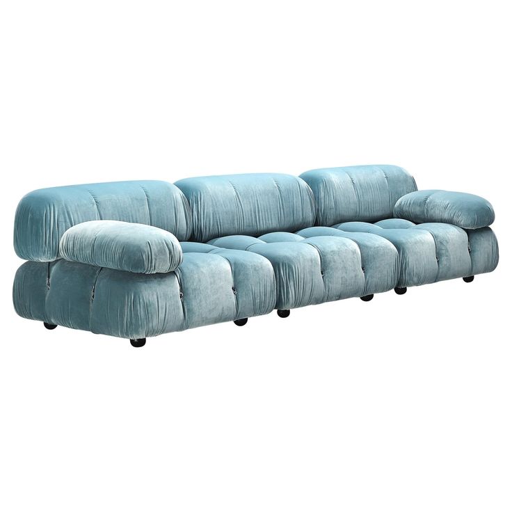 a blue couch sitting on top of a white floor