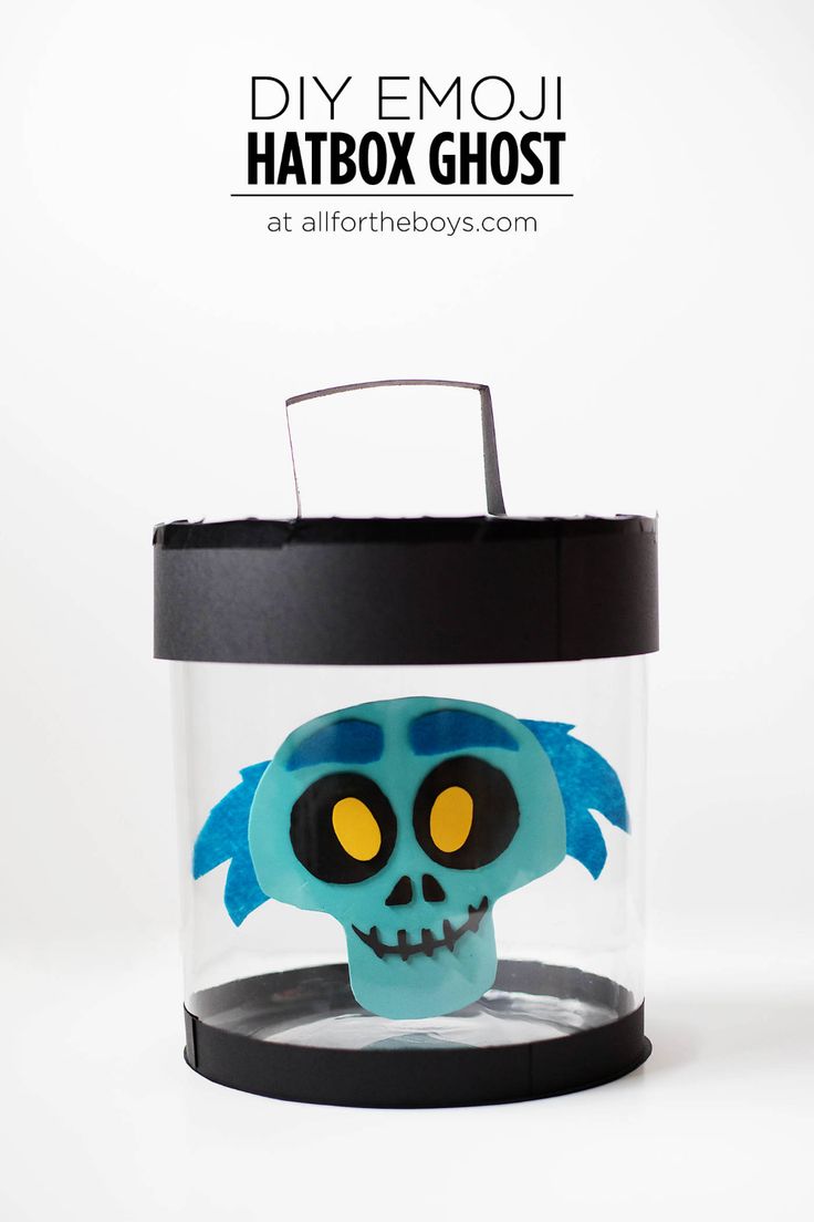 a blue skull in a glass container with the words diy emoui hatbox ghost