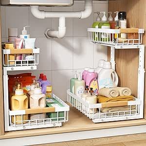 two white baskets filled with cleaning products on top of a counter