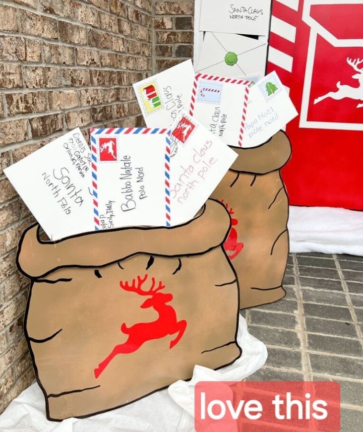 some mail bags are sitting on the ground next to a brick wall with postcards in them