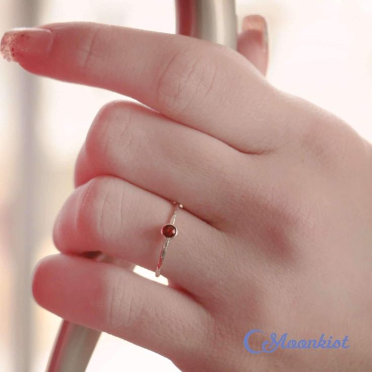 Dainty Silver Garnet Pinky Ring | Moonkist Designs Dainty Birthstone Midi Rings For Gifts, Dainty Round Cut Ruby Ring, Dainty Ruby Ring With Birthstone, Minimalist Solitaire Birthstone Ring As Gift, Dainty Bezel Set Midi Rings With Round Band, Adjustable Minimalist Solitaire Birthstone Ring, Adjustable Dainty Stackable Rings With Bezel Setting, Dainty Everyday Birthstone Ring, Dainty Birthstone Ring For Everyday