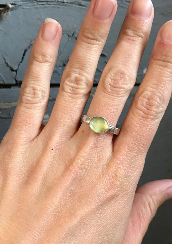 Choose from an oval prehnite, moonstone, aqua chalcedony, pink chalcedony, or white howlite turquoise as the accent stone for this stunning  hand hammered ring. Each stone is 10mm x 8mm in size. The ring band is 3mm in size. Made to order! Choose your size and your stone. Oval Citrine Green Jewelry, Oval Green Citrine Jewelry, Adjustable Oval Cabochon Moonstone Ring, Everyday Jewelry With Oval Natural Stones, Everyday Round Citrine Jewelry, Everyday Oval Jewelry With Natural Stones, Everyday Oval Natural Stone Jewelry, Everyday Citrine Jewelry, Green Citrine Round Jewelry