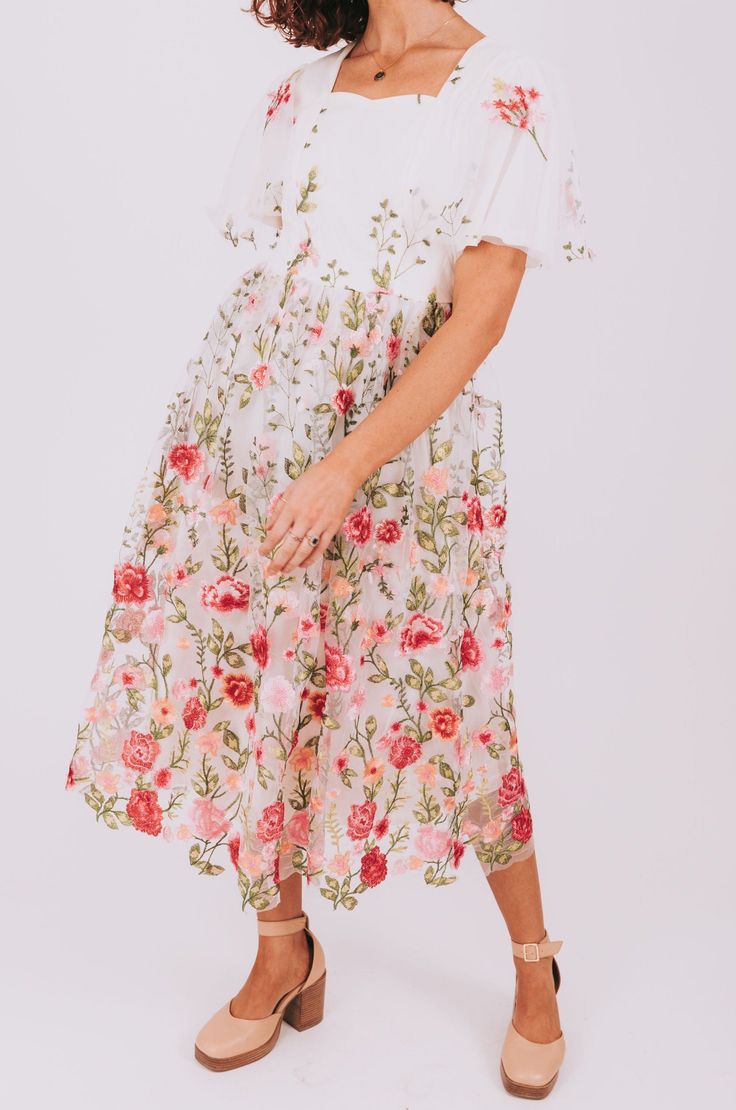 Channel your inner flower child with our Reminds Me Of You dress! This dress features a flowy square neckline and flowy sleeves, all fully lined for comfort. The mesh overlay is adorned with delicate embroidered flowers, making you feel like a walking garden. Details Square neckline Flowy sleeves Fully lined Mesh overlay with embroidered flowers Sizing Approximate measurements: SIZE LENGTH BUST Small 49" 35" Medium 49.5" 37" Large 49.5" 40" XL 50" 43" Fabric has no stretchModel is 5’10” and wear Summer Floral Dress With Applique For Garden Party, Summer Floral Applique Dress For Garden Party, Floral Applique Dress For Summer Garden Party, Spring Floral Applique Midi Dress For Garden Party, Summer Wedding Midi Dress With Floral Embroidery, Spring Floral Applique Midi Dress, Feminine Flowy Dress With Floral Embroidery, Flowy Floral Embroidered Feminine Dress, Flowy Feminine Dress With Floral Embroidery