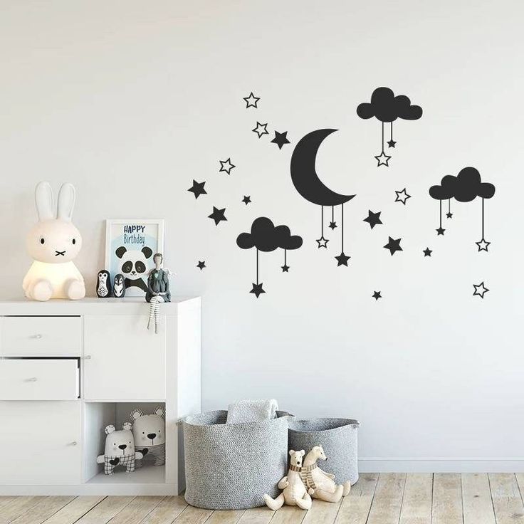 a child's room with stars, clouds and moon decals on the wall