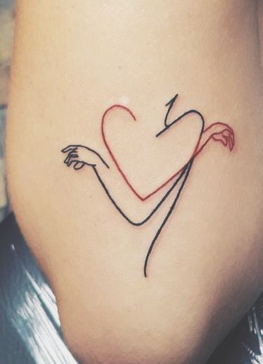 a woman's stomach with a heart and arrow tattoo on the side of her thigh