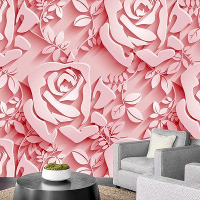 a living room with a couch, chair and wallpaper that has pink roses on it