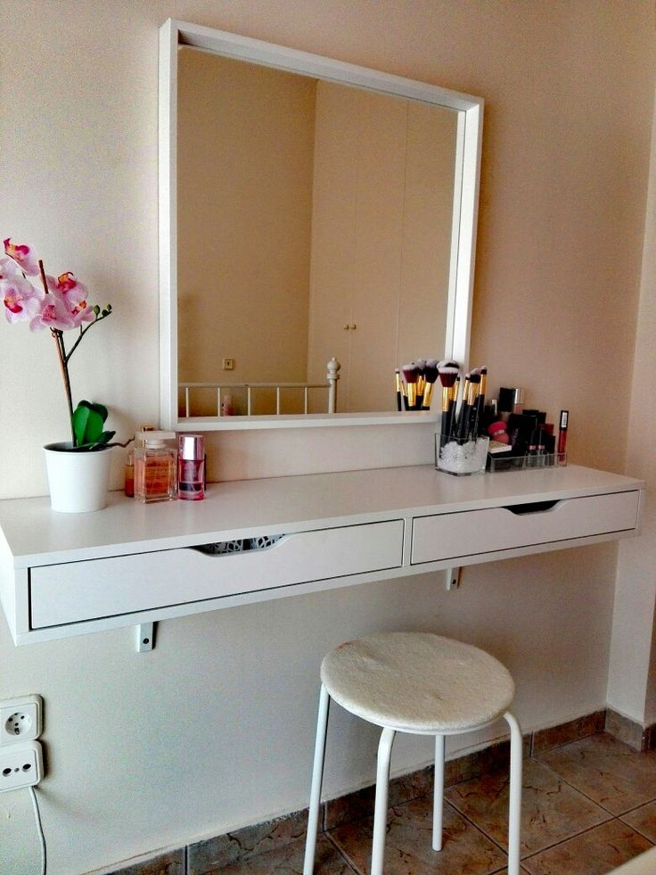 a white desk with a mirror and stool