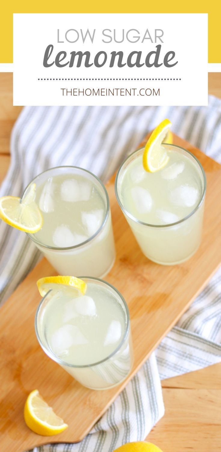 three glasses filled with lemonade sitting on top of a cutting board next to sliced lemons