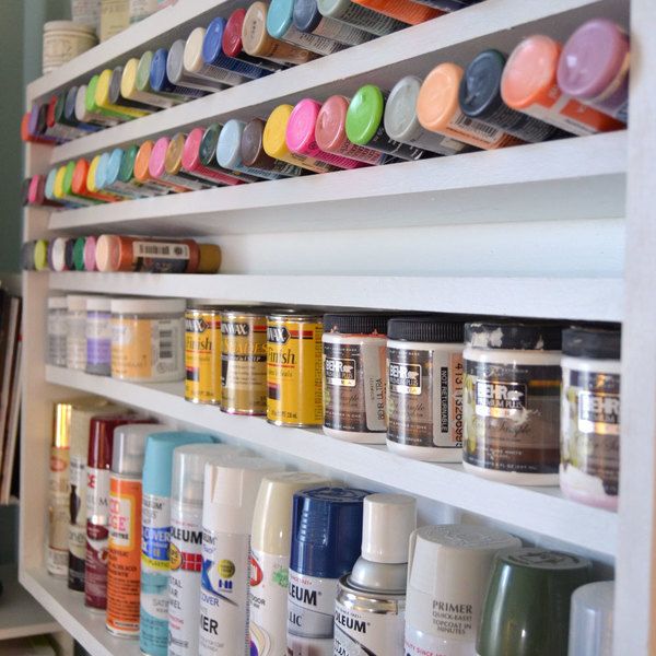 the shelves are filled with many different types of paint