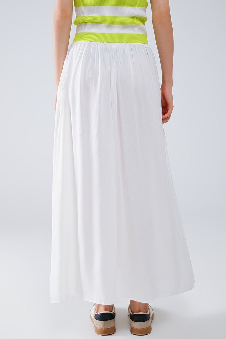 Introducing our stunning Maxi Skirt in White Fluid Fabric with Elastic Waist, a versatile and chic addition to your wardrobe that exudes effortless bohemian style. Crafted from lightweight woven fabric made of 100% viscose, this skirt offers both comfort and elegance.  The full-length design and relaxed fit create a flowing silhouette that's perfect for any occasion, whether you're strolling along the beach or attending a summer soirée. The elastic waistband ensures a comfortable and customizable fit, while side pockets add a practical touch.  Pair this skirt with a simple tank top for a casual daytime look, or dress it up with a blouse and statement jewelry for a more polished ensemble. However you style it, this maxi skirt is sure to make a statement wherever you go.  Please note that th