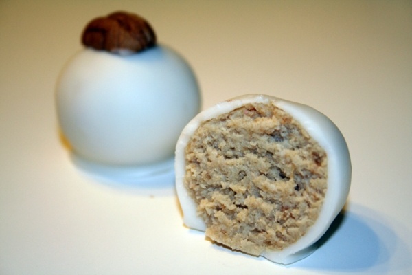 two pieces of food sitting on top of a white table next to an egg shell