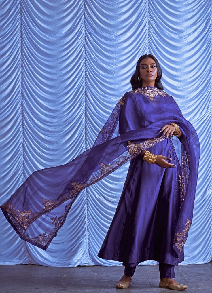 Purple Chanderi Silk Angrakha (overlapping Kurta) embellished with the signature vintage gold Peacock motifs and tassels teamed with matching pants. Completed with a matching hand embroidered organza dupatta. Can be colour customised in any colour - check green at the end Composition : Kurta and Pants : Chanderi Silk, Dupatta - Organza Care: Dry Clean Only and Vacuum Storage This product can be customised for sleeves, length of blouse and neckline Delivery : 4-6 weeks as the product is hand crafted. For more information and sizes please contact fabiliciousfashion@gmail.com or visit our Copenhagen studio. About the Designer : Pink City by Sarika, established in 2014, is a young and modern brand that offers modern indo western silhouettes with old world sophistication. With a meticulous eye Kurta And Pants, Peacock Motifs, Gold Peacock, Purple Peacock, Pink City, Vacuum Storage, Embroidered Organza, Organza Dupatta, Indo Western