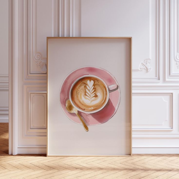 a cup of cappuccino on a pink saucer in front of a white wall