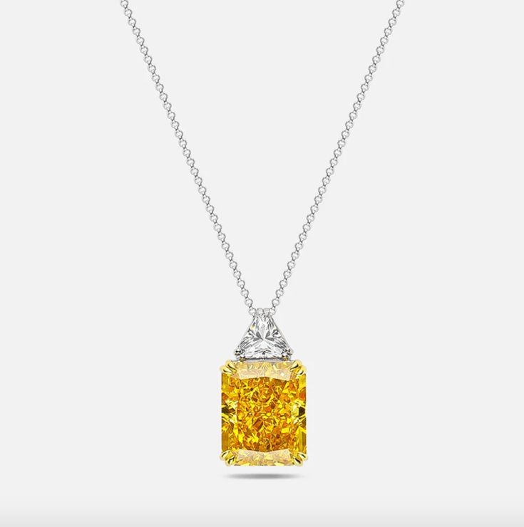 Our divine radiant cut fancy yellow pendant. This necklace makes an exceptional gift. Pendant Details: Stone style: Radiant Cut Stone colours: Fancy Yellow Stone Size: 13mm x 16mm Setting: 925 Sterling Silver Chain, Golden Prongs Occasion: Bridal, Black Tie, Everyday Elegant Emerald Cut Yellow Jewelry, Elegant Yellow Emerald Cut Jewelry, Luxury Yellow Necklace With Diamond Accents, Luxury Yellow Necklaces With Diamond Accents, Yellow Cushion Cut Jewelry With Prong Setting, Yellow Gold Necklace With Radiant Cut Prong Setting, Yellow Gold Radiant Cut Necklace With Prong Setting, Yellow Radiant Cut Jewelry For Wedding, Radiant Cut Yellow Jewelry For Wedding