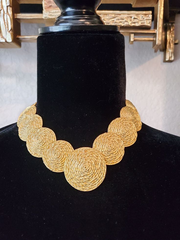 This fabulous chunky 90's gold-tone choker bib necklace is the perfect addition to your vintage jewelry collection! This piece is by AFJ  and is made of gold-toned brushed embossed metal. Perfect for casual looks and formal looks alike.  Get it for yourself or as a gift for someone in your life who loves vintage jewelry! This designer piece is amazing and a true statement piece :) Total Length 16 inches Neck Drop 6.5 inches US SHIPPING  FREE  International shipping please see rate Please add our shop as a ❤ favorite so you can find us again! Our website is MinxandOnyx.com Www.facebook.com/minxandonyx @minxandonyx follow us on Instagram  Thank you for shopping at Minx and Onyx! Luxury Vintage Necklace With Large Beads, Gold Bib Necklace Costume Jewelry, Gold Costume Jewelry Bib Necklace, Gold Vintage Bib Necklaces For Gifts, Vintage Gold Bib Necklace Gift, Vintage Gold Round Choker, Gold Bib Choker Costume Jewelry, Gold Choker Bib Necklace As Costume Jewelry, Gold Retro Choker