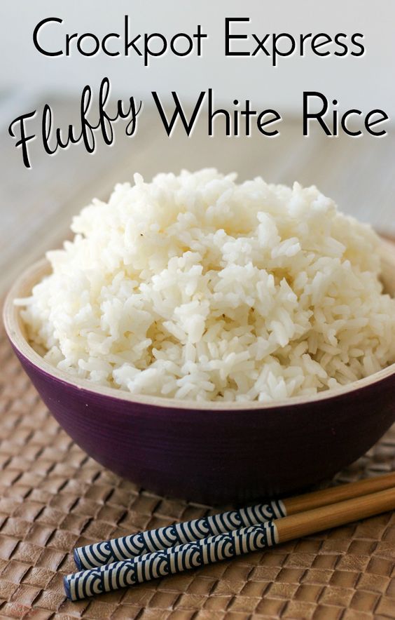 a purple bowl filled with white rice next to chopsticks