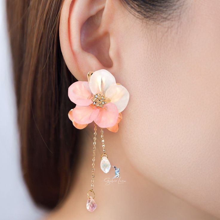 These elegant pink flower fashion earrings features a cute big pink flower and a long tail as back piece that you can wear with or without it. Add these cute flower fashion statement earrings to your everyday fashion earrings collection or as gift for your love one. Jewelry Care: See more information about how to care for your jewelry here. Shipping Policy: Orders will be shipped within 1-3 business days. Economy shipping will take 7-14 days to arrive and standard shipping is 1- 4 days for U.S. Trendy Flower Earrings For Wedding, Trendy Flower-shaped Earrings For Wedding, Dangle Flower Earrings With 3d Flowers, Trendy Wedding Flower Drop Earrings, Cute Flower Jewelry For Party, Cute Flower-shaped Party Jewelry, Feminine Dangle Flower Earrings, Feminine Pink Jewelry With Handmade Flowers, Elegant Pink Teardrop Flower Earrings